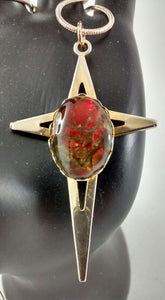 Close up of ammolite on gold-colored cross